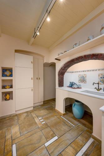 a kitchen with a counter and a table in a room at Passion Blue Villas in Oia