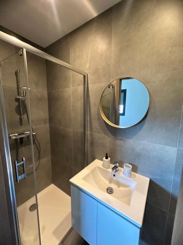 a bathroom with a sink and a shower and a mirror at chambre au calme in Saint-Jean-dʼArvey