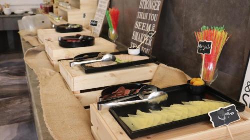 a table with wooden boxes with food on it at Sandy palace Hotel in Amman