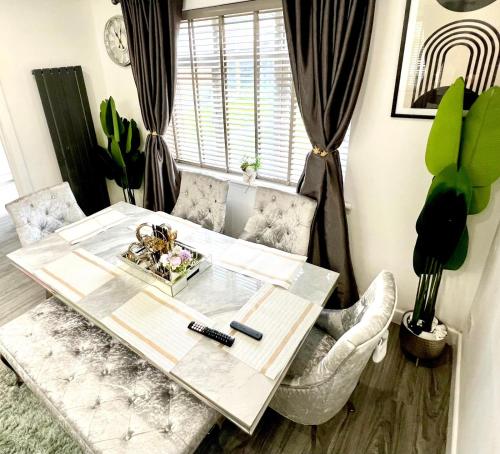 a table and chairs in a living room at Home away from home in Bury