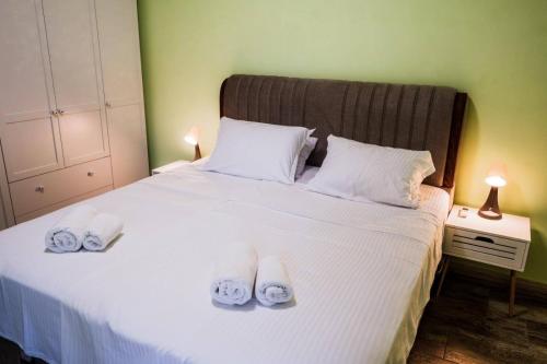 a bedroom with a white bed with towels on it at Garden Apartment Fichoza 2 - 80m from the sea in Varna City