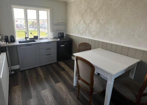 a kitchen with a table and chairs and a sink at Hótel Blönduós in Blönduós
