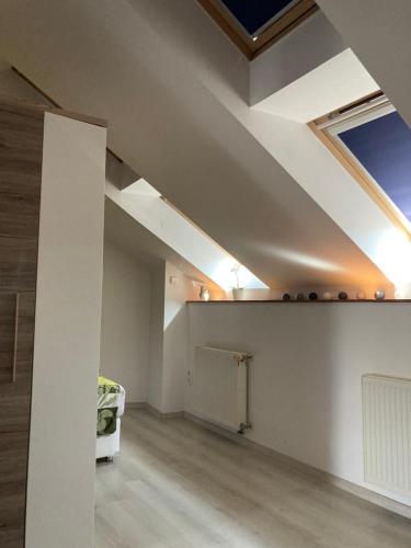 an attic room with a skylight on the ceiling at Esztergom apartman in Esztergom