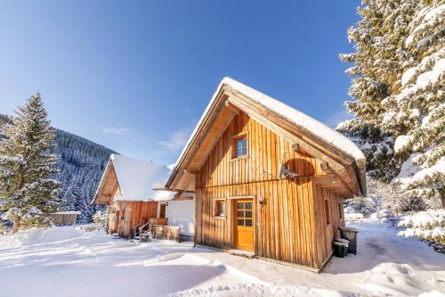 a log cabin in the snow at Holzmeisterhütte Teichalm-Sommeralm in Sankt Kathrein am Offenegg