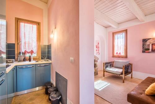 a kitchen and a living room with a couch at ISA-Chalet with common swimming-pool surrounded by Tuscan nature in Trequanda