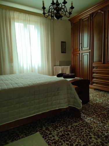 a bedroom with a bed and a large window at Podere Gian Battaglia in Fucecchio
