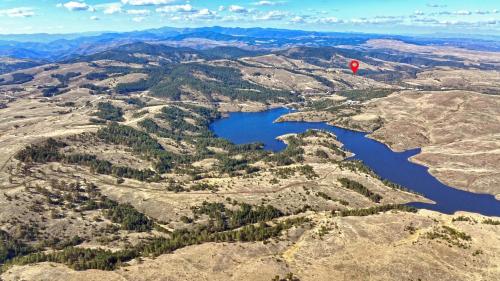 a hot air balloon flying over a mountain lake at Zlatiborski katuni in Zlatibor