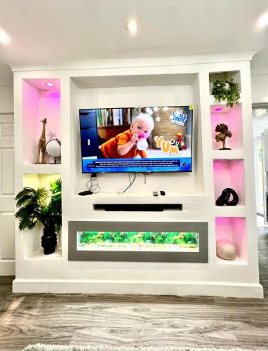 a living room with a flat screen tv on a white wall at Home away from home in Bury