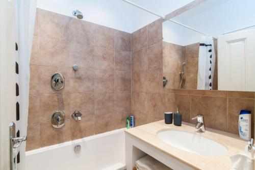 a bathroom with a sink and a bath tub at Style&Art Apartment in Budapest