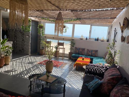 a living room with a couch and a table at Amazigh surf house in Agadir