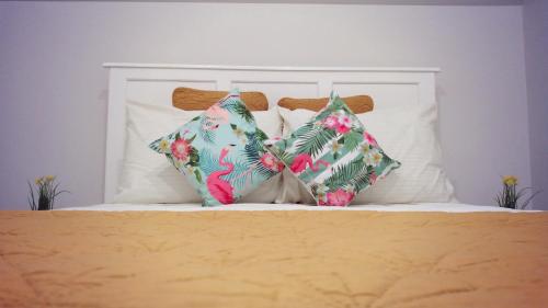 a bed with two pillows on top of it at Mcgregor House - Villa by The Bay in Nassau