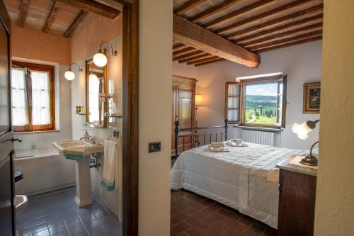 a bedroom with a bed and a tub and a sink at Villa with swimming pool in San Gimignano in San Gimignano