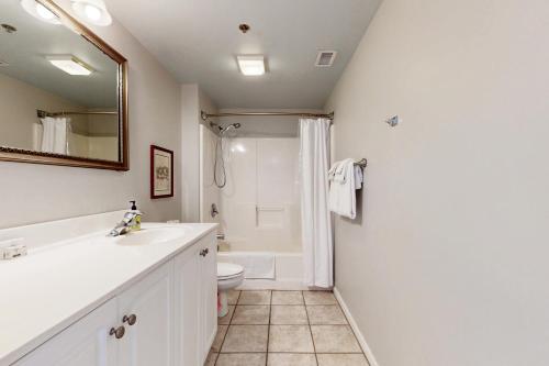a bathroom with a sink and a toilet and a shower at River View Condo A in Wilmington