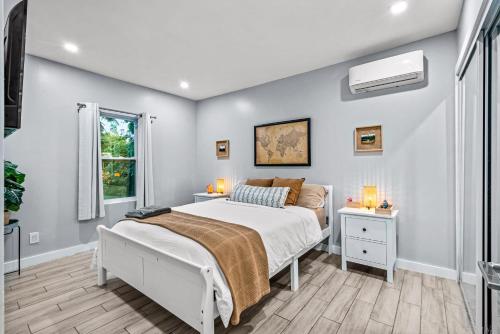 a bedroom with a bed and a window at Zen Retreat - Sauna Pool Cold Plunge & More in Fort Lauderdale