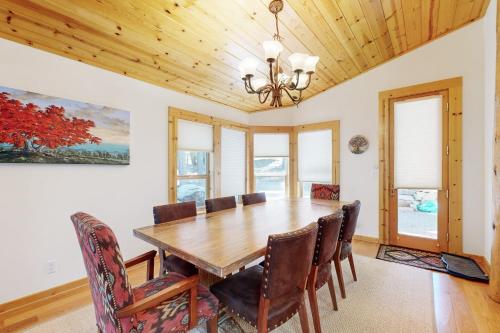 a dining room with a wooden table and chairs at Wooded Luxury at Tahoe Donner in Truckee