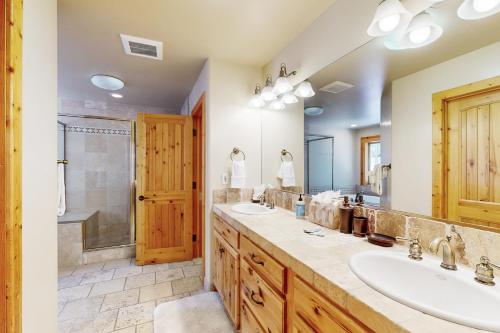 a bathroom with two sinks and a shower at Wooded Luxury at Tahoe Donner in Truckee