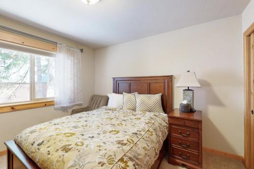 a bedroom with a bed and a window at Wooded Luxury at Tahoe Donner in Truckee