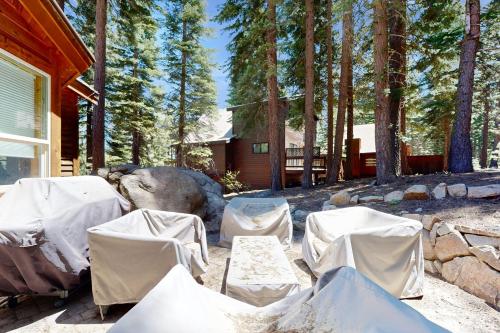 a group of chairs and tables in front of a house at Wooded Luxury at Tahoe Donner in Truckee