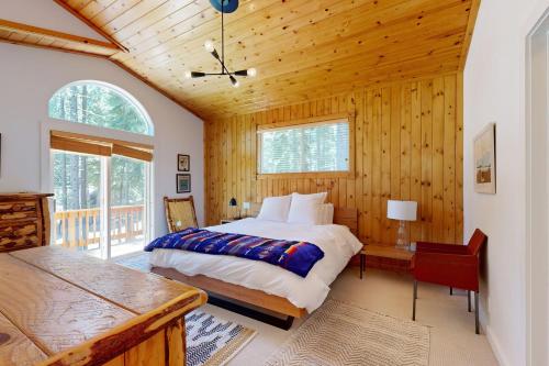 a bedroom with a bed and a wooden ceiling at Tyrol Getaway in Truckee