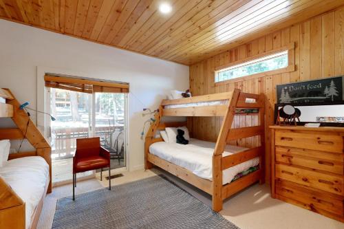 a bedroom with two bunk beds and a desk at Tyrol Getaway in Truckee