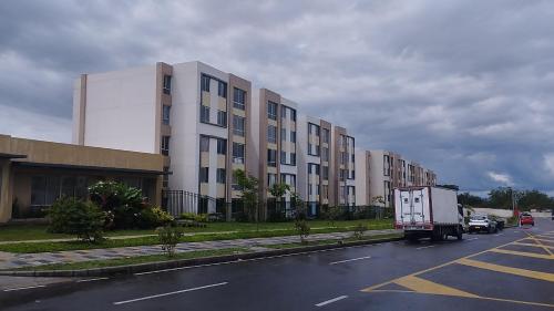 a white truck parked in front of a building at Apartamento Ibagué in Ibagué