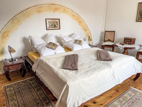 a bedroom with a large white bed with a large arch at Apartment Speicher by Interhome in Gingst