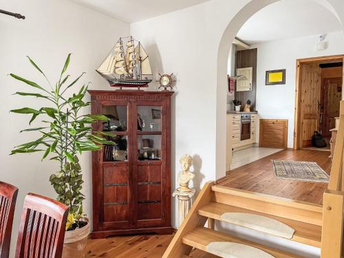 a dining room with a table and a wooden cabinet at Apartment Speicher by Interhome in Gingst