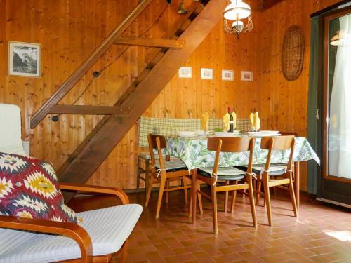 a dining room with a table and chairs at Holiday Home Chalet Al Portic by Interhome in Scona