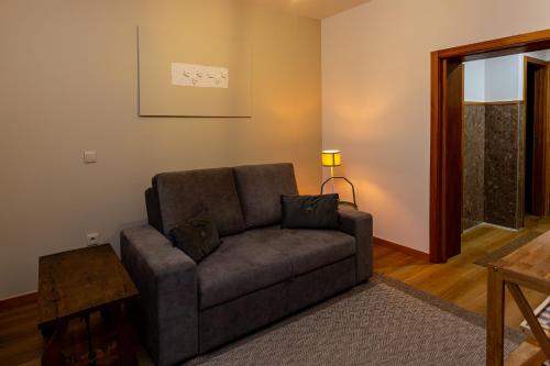 a living room with a couch and a table at 714 Mugnano House Aveleda in Vila do Conde