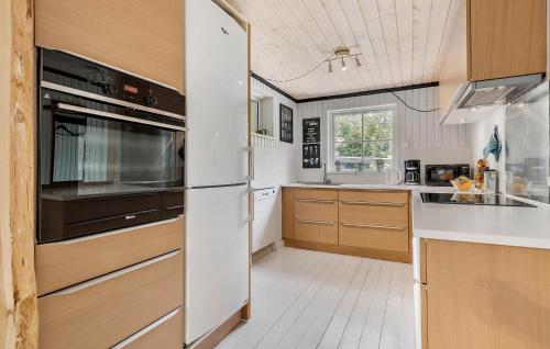 a kitchen with a refrigerator and a sink at 2 Bedroom Stunning Home In Gistrup in Gistrup