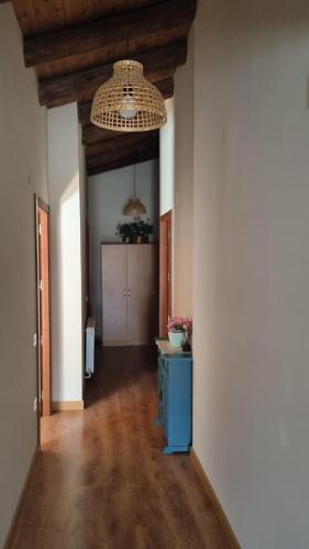 a hallway with a blue cabinet and a ceiling at Casa Tropiet in Beceite
