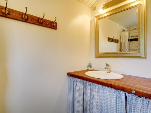 a bathroom with a sink and a mirror at Holiday Home Leani - 200m from the sea by Interhome in Stubbekøbing