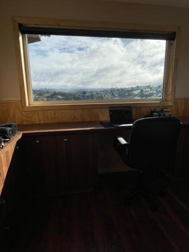 an office with a window and a desk with a laptop at Cabaña de Lujo en Llau Llao, con agua purificada, confort y bienestar con especial cuidado ambiental, hermosa vista, estratégicamente ubicada entre Castro y Dalcahue in Tentén