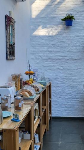 a table with a bunch of food on it at Posada El Capullo in Colonia del Sacramento