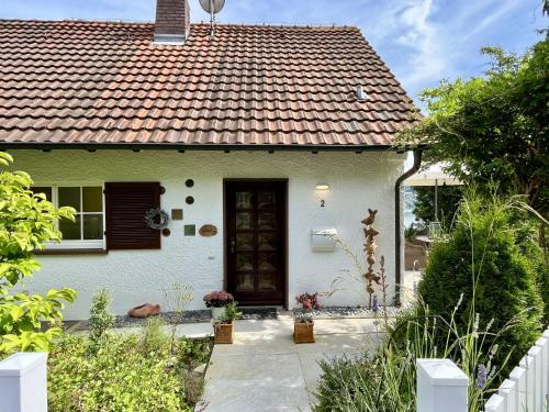 a white house with a red roof at Holiday Home Seepanorama by Interhome in Wangen