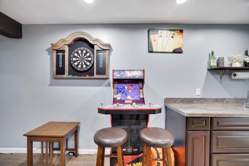 a kitchen with a stove and a bar with stools at Cozy cottage in the heart of pocono in Long Pond