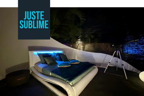 a bedroom with a bed with a camera at Nuit insolite dans une bulle avec spa privatif en Martinique! in Rivière-Salée