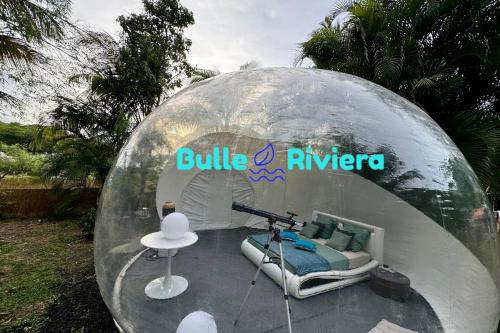 a clear dome house with a bed in it at Nuit insolite dans une bulle avec spa privatif en Martinique! in Rivière-Salée