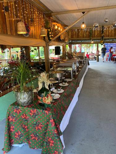 a buffet line with tables with plants on them at Pousada Paraíso das Águas in Itirapina