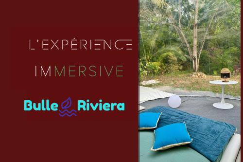 a sign that saysiane experience interactive and a table with pillows at Nuit insolite dans une bulle avec spa privatif en Martinique! in Rivière-Salée