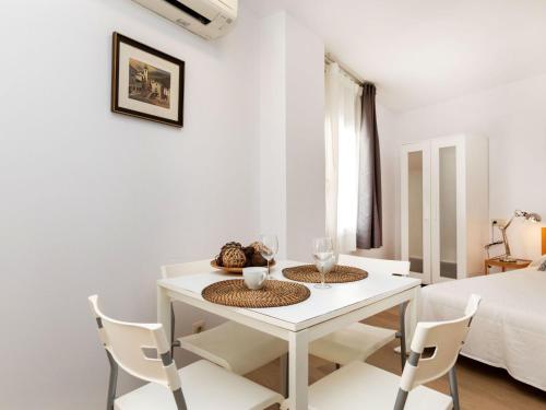 a white dining room with a white table and chairs at Apartment Marinada by Interhome in Tossa de Mar