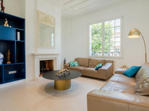 a living room with a couch and a table at Holiday Home Villa Deauville by Interhome in Deauville