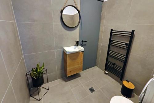 a bathroom with a sink and a mirror at Village Villa, Agios Georgios Grevena in Grevena