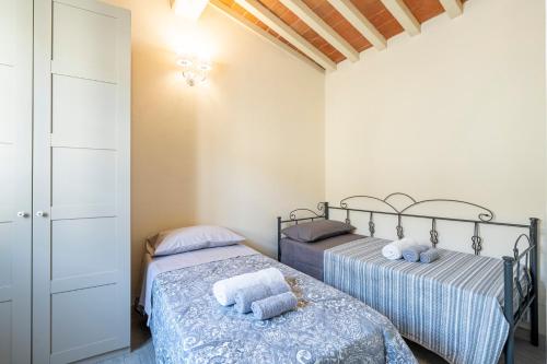 Ένα ή περισσότερα κρεβάτια σε δωμάτιο στο Colonica Toscana