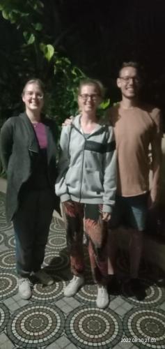 a group of three people standing on a sidewalk at Sahana Villa in New Hampi