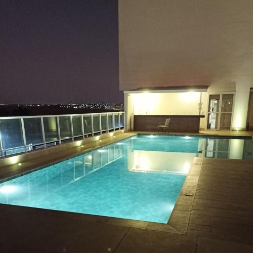 a swimming pool on top of a building at night at Sleep Inn Paulínia in Paulínia