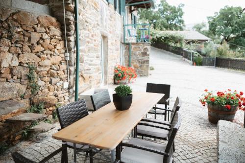 a wooden table and chairs on a patio at Quinta da Malhada in Cabril