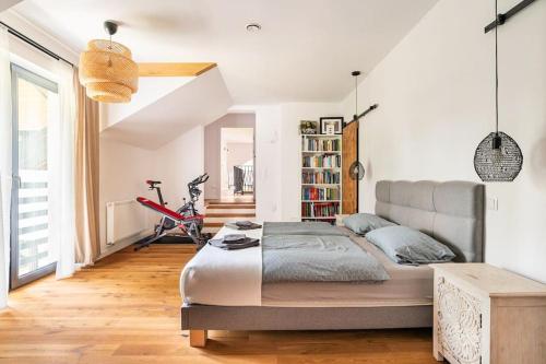 a bedroom with a bed and a bike in it at Parkowa Garden in Michałowice