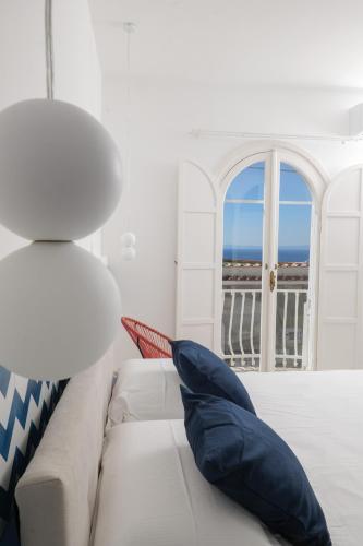 a living room with a white couch and a window at La Maison De La Ville in Massa Lubrense