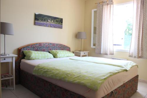 une chambre avec un lit et une fenêtre dans l'établissement Dodo au Luberon, à Villars